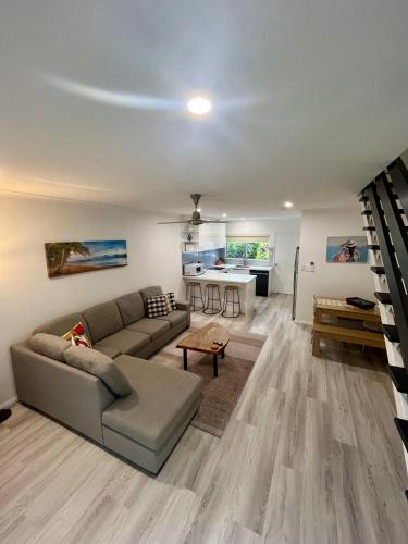 a living room with a couch and a table at The Lazy Break at Trinity in Trinity Beach