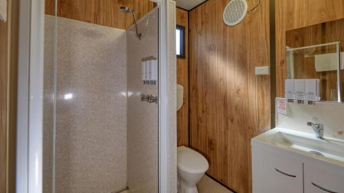 a bathroom with a shower and a toilet and a sink at BIG4 Barham Holiday Park in Barham