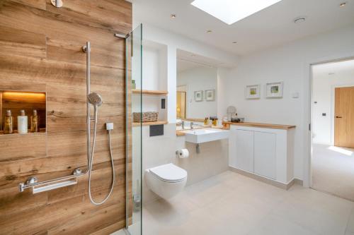 a bathroom with a shower and a toilet and a sink at 4 Bed in Rattray oc-e31983 in Alyth
