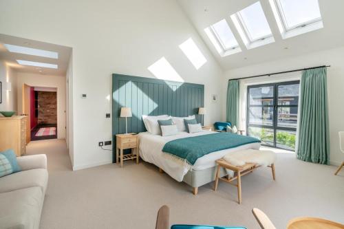 a bedroom with a large bed and a couch at 4 Bed in Rattray oc-e31983 in Alyth