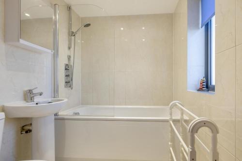 a bathroom with a tub and a sink and a shower at 2 Bed in West Bay oc-d31037 in West Bay