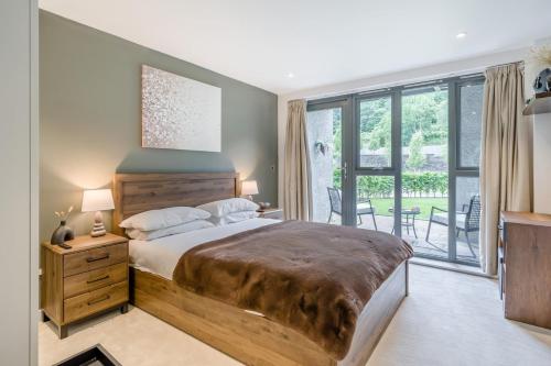a bedroom with a large bed and a balcony at 1 Bed in Backbarrow oc-s32477 in Backbarrow