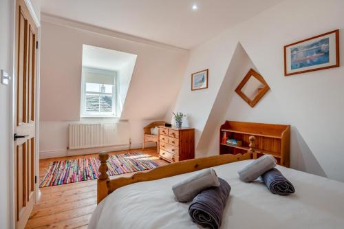 a bedroom with a bed and a dresser and a window at 2 Bed in Langton Matravers oc-d28351 in Langton Matravers
