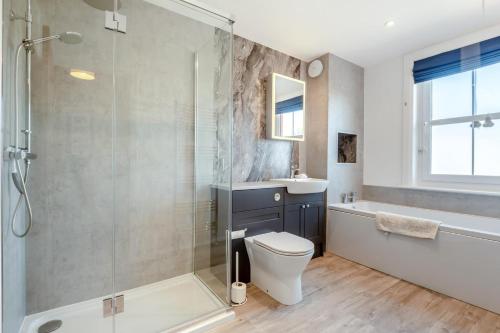 a bathroom with a shower and a toilet and a sink at 2 Bed in Langton Matravers oc-d28351 in Langton Matravers