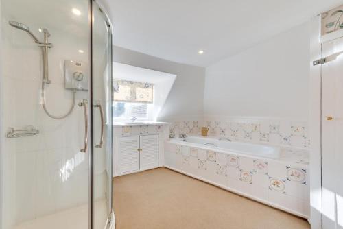 a bathroom with a shower and a bath tub at 4 Bed in Barham oc-ct016 in Barham