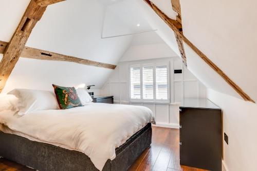 a bedroom with a large bed in a attic at 3 Bed in Arundel oc-bt007 in Arundel
