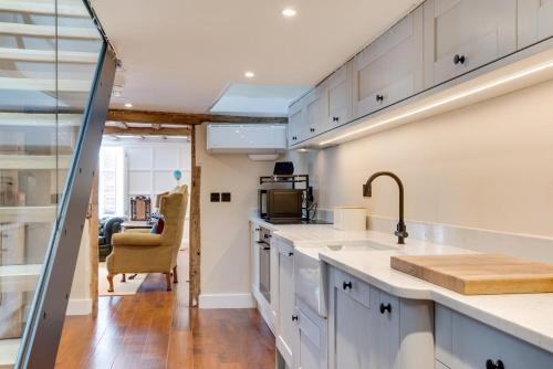 a kitchen with white cabinets and a sink at 3 Bed in Arundel oc-bt007 in Arundel