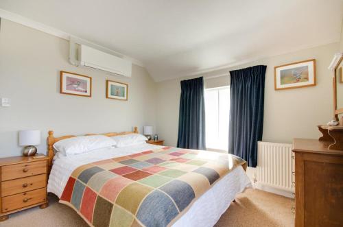 a bedroom with a large bed and a window at 2 Bed in Holt oc-1449 in Holt