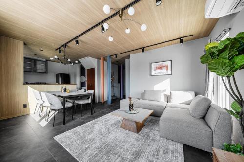 a living room with a couch and a table at Astage Villa Kamifurano in Kami-furano