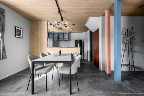 a dining room with a table and chairs at Astage Villa Kamifurano in Kami-furano