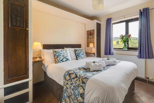 a bedroom with a large bed and a window at 4 Bed in Hawes oc-ds940 in Hawes