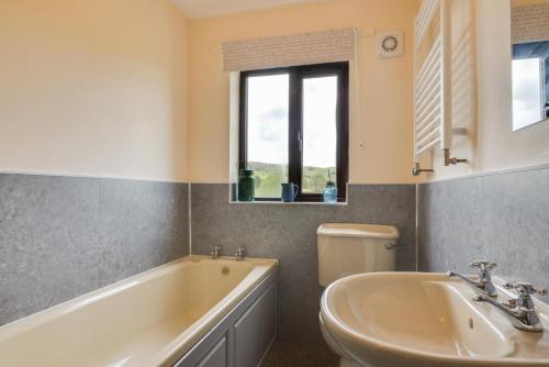 a bathroom with a tub and a sink at 4 Bed in Hawes oc-ds940 in Hawes