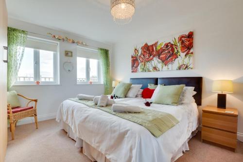 a bedroom with a large bed with white sheets at 4 Bed in North Sunderland oc-gd1890 in North Sunderland