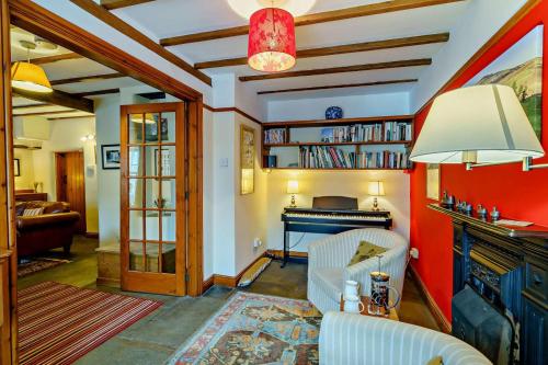 a living room with a couch and a piano at 3 Bed in Hawes oc-hhmy23 in Hawes