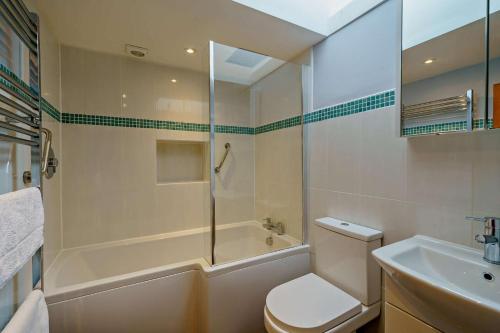 a bathroom with a shower and a toilet and a sink at 3 Bed in Hawes oc-hhmy23 in Hawes