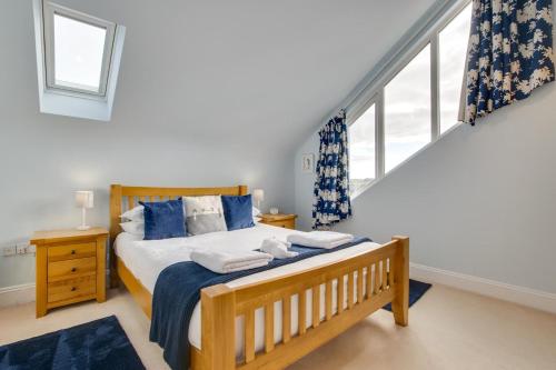 a bedroom with a large bed with blue pillows at 3 Bed in Fowey oc-p00755 in Fowey