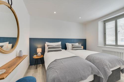 a bedroom with two beds and a mirror at 2 Bed in Padstow oc-p00876 in Padstow