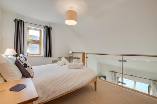 a bedroom with a large white bed and a window at 2 Bed in Porthleven oc-quaysi in Porthleven