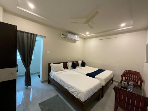 a bedroom with a large bed in a room at MGR RESIDENCY in Srikalahasti