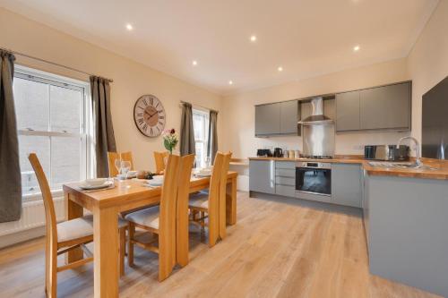 a kitchen and dining room with a wooden table and chairs at 3 Bed in Saundersfoot oc-pw9274 in Saundersfoot