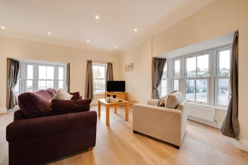 a living room with two couches and a tv at 3 Bed in Saundersfoot oc-pw9274 in Saundersfoot