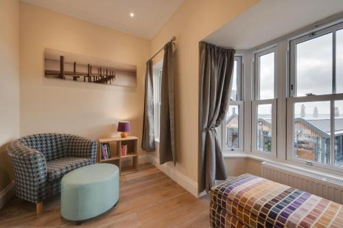 a living room with a chair and a window at 3 Bed in Saundersfoot oc-pw9274 in Saundersfoot