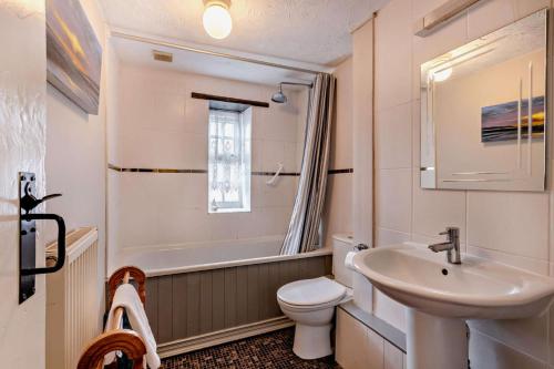 a white bathroom with a sink and a toilet at 3 Bed in Brancaster oc-p28395 in Brancaster