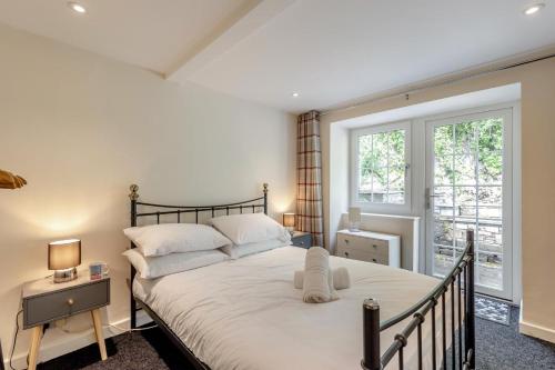 a bedroom with a large bed and a window at 3 Bed in Aberdovey oc-v29263 in Aberdyfi