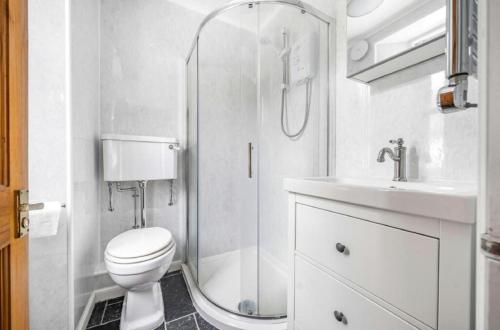 a bathroom with a shower and a toilet and a sink at 2 Bed in Looe oc-a29612 in Looe