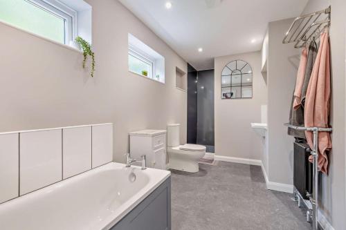 a white bathroom with a tub and a toilet at 3 Bed in Timsbury oc-h29584 in Timsbury