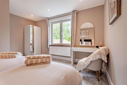 a bedroom with a bed and a mirror and a window at 3 Bed in Timsbury oc-h29584 in Timsbury