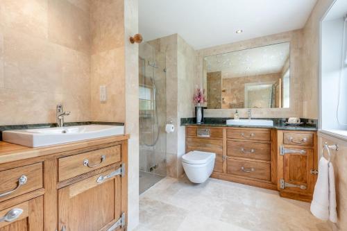 a bathroom with a sink and a toilet and a shower at 4 Bed in Wareham oc-r30563 in Wareham