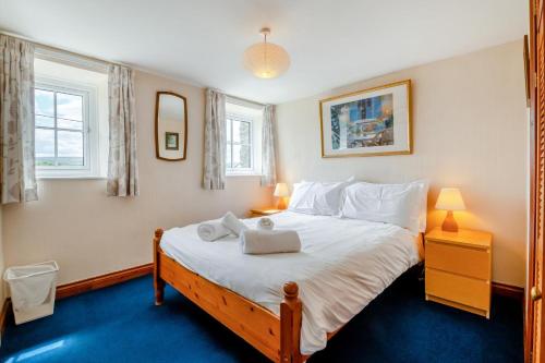a bedroom with a large bed with two towels on it at 3 Bed in Carperby oc-e30625 in Carperby