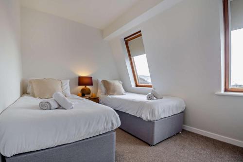 two beds in a room with two windows at 3 Bed in Aberdovey oc-n29124 in Aberdyfi
