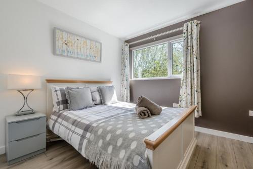 a bedroom with a bed and a window at 3 Bed in Bush oc-m31847 in Bude