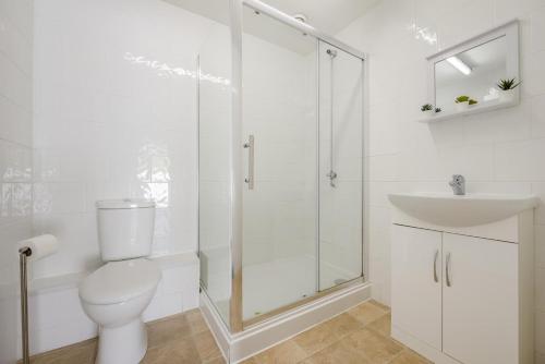 a bathroom with a shower and a toilet and a sink at 3 Bed in Bush oc-m31847 in Bude