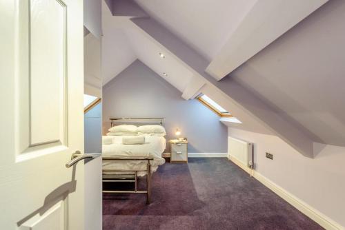 a bedroom with a bed in a attic at 2 Bed in Tenby oc-w28985 in Tenby