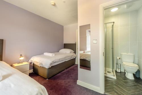 a bedroom with two beds a toilet and a shower at 2 Bed in Tenby oc-w28985 in Tenby