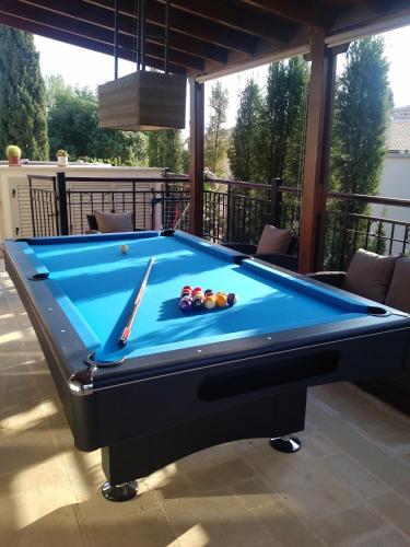 a pool table sitting on top of a patio at Villa UNIDERA in Kouklia