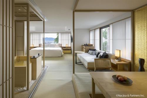 a hotel room with a bed and a table at Banyan Tree Higashiyama Kyoto in Kyoto