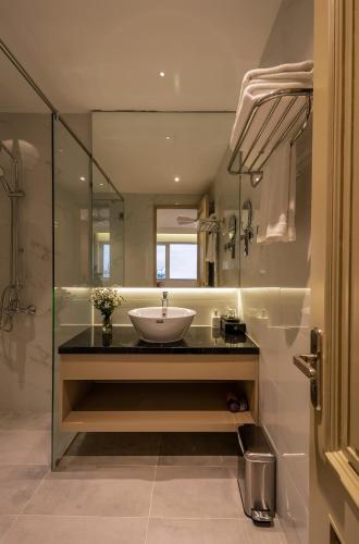 a bathroom with a sink and a glass shower at Palago Binh Thanh Hotel in Ho Chi Minh City