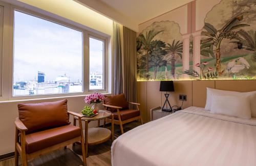 a hotel room with a bed and a window at Palago Binh Thanh Hotel in Ho Chi Minh City