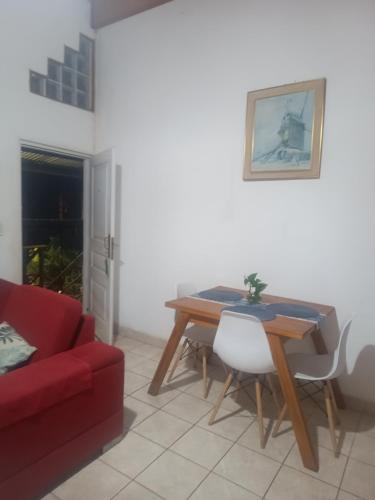 a living room with a table and a red couch at El Portal in Posadas