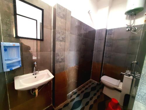 a bathroom with a sink and a toilet at Gladden Villa in Udaipur