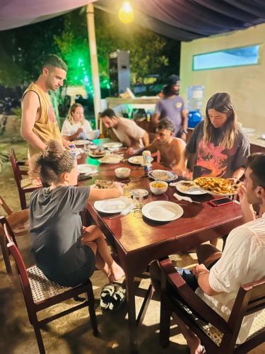 a group of people sitting around a table eating at Kiteclub in Kalpitiya