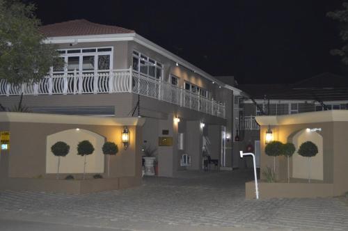 a building with a balcony on the side of it at night at Lakeview Boutique Hotel & Conference Center in Benoni