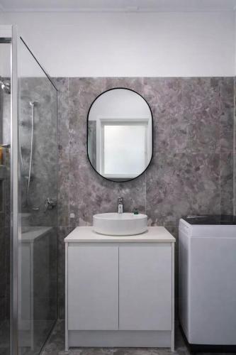 a bathroom with a white sink and a mirror at Entire New renovated 2bedrm unit next to southbank in Brisbane