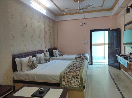 a bedroom with a bed and a table in it at Hotel Rising Sun in Bacha