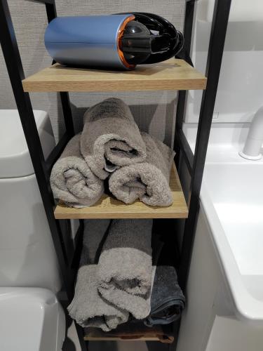 a towel rack with towels on it in a bathroom at ステイインアット勝富 in Sasebo