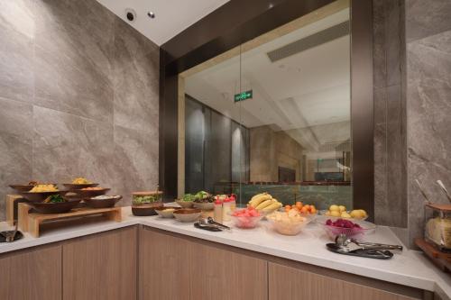 a buffet line with a variety of food on it at Atour Hotel Xiaolan Zhongshan in Zhongshan